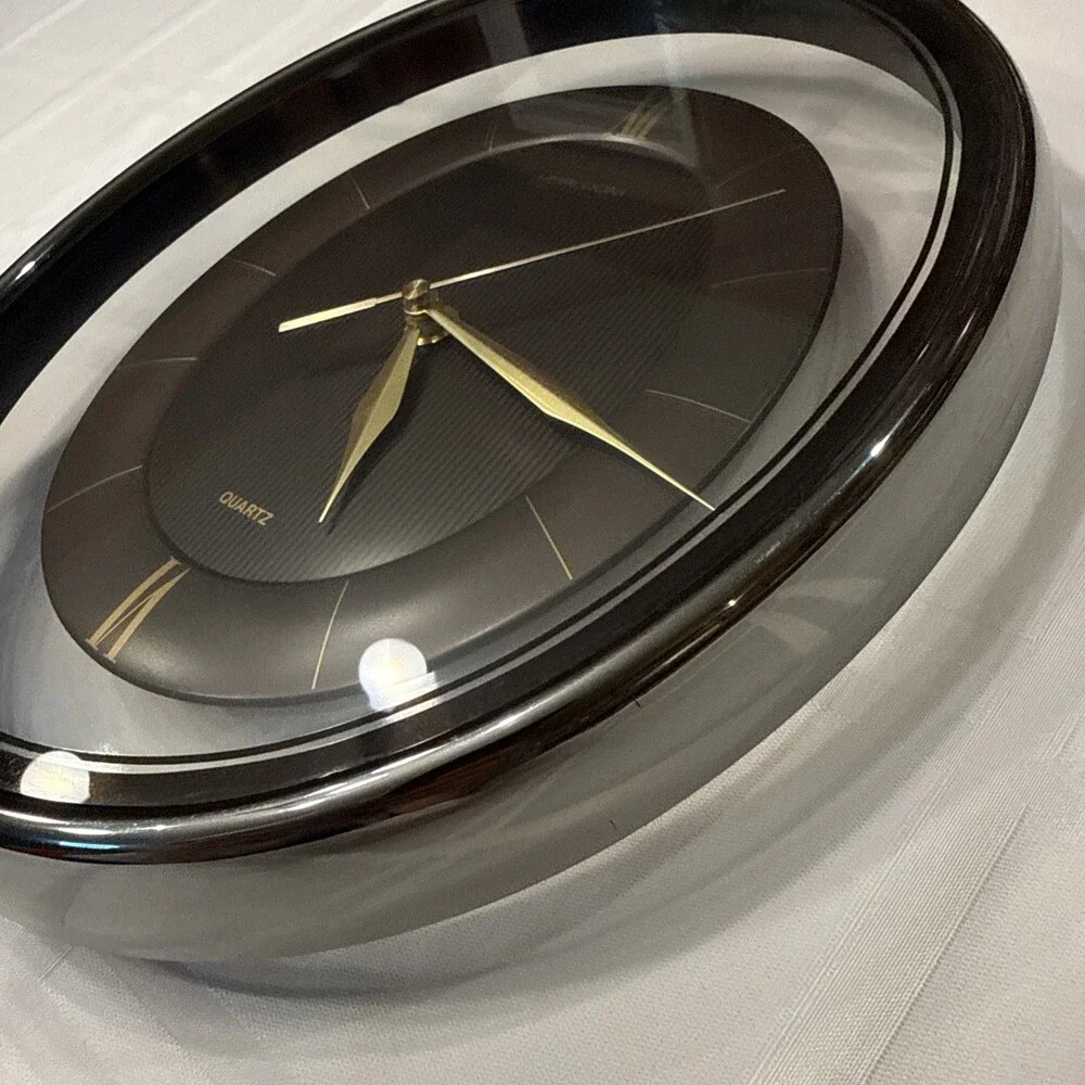 Vintage 1980s Heirloom Quartz Wall Clock Clear Lucite Floating Oval Black Gold